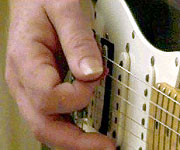 Holding the plectrum.