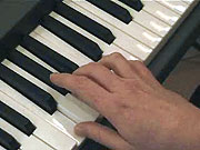 Playing the chord of F.